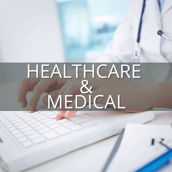 Clinician typing on a keyboard beside patient notes