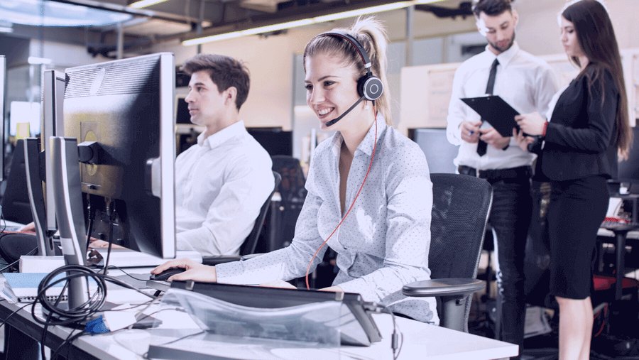 InVision support staff taking calls at their desks wearing headsets